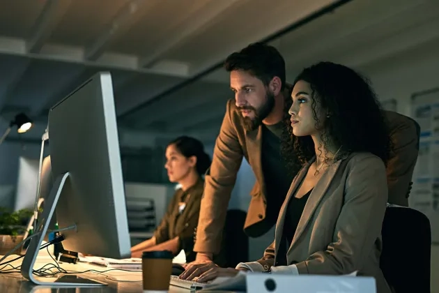 Man and woman behind pc