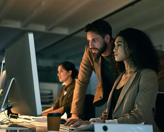 Man and woman behind pc